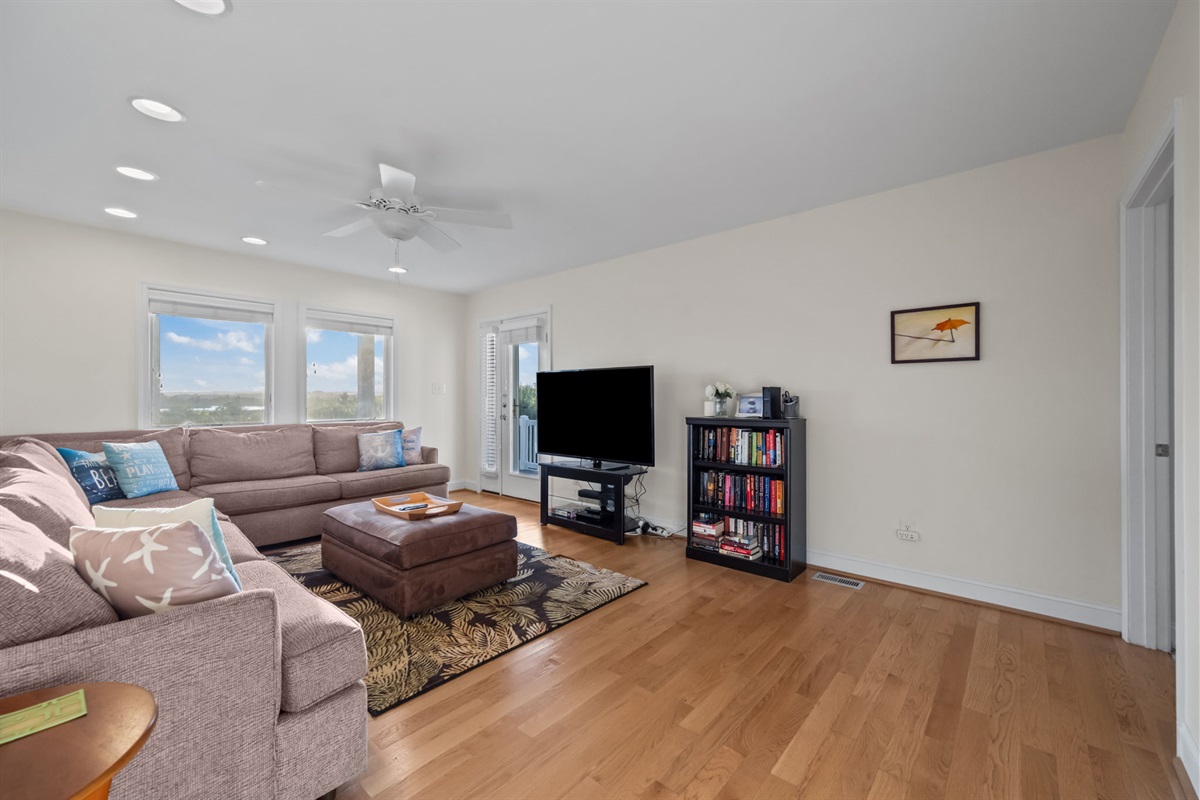 Spacious family room with large sectional and natural light