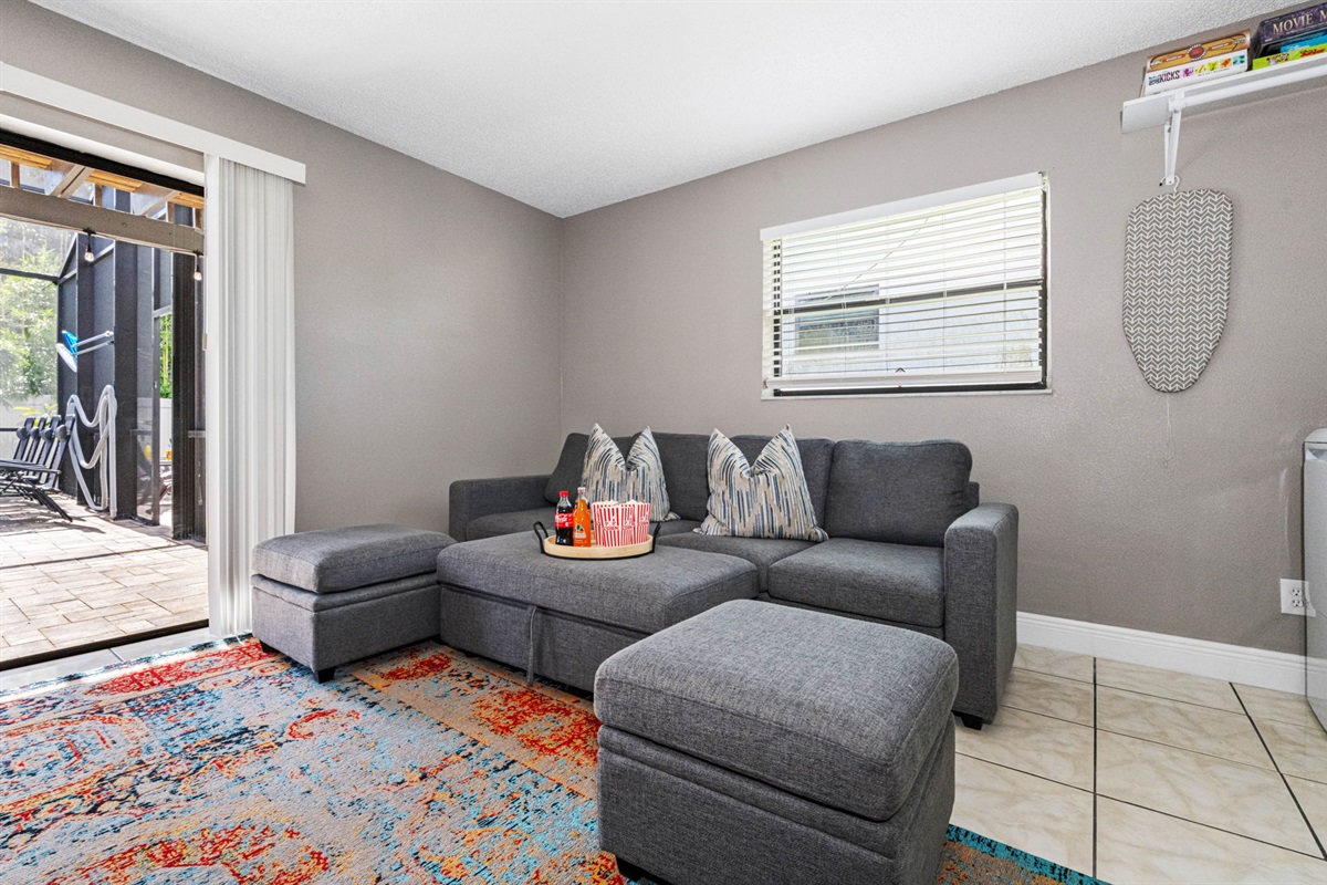This spacious lounge-style living room is designed with comfort, color, and entertainment in mind.