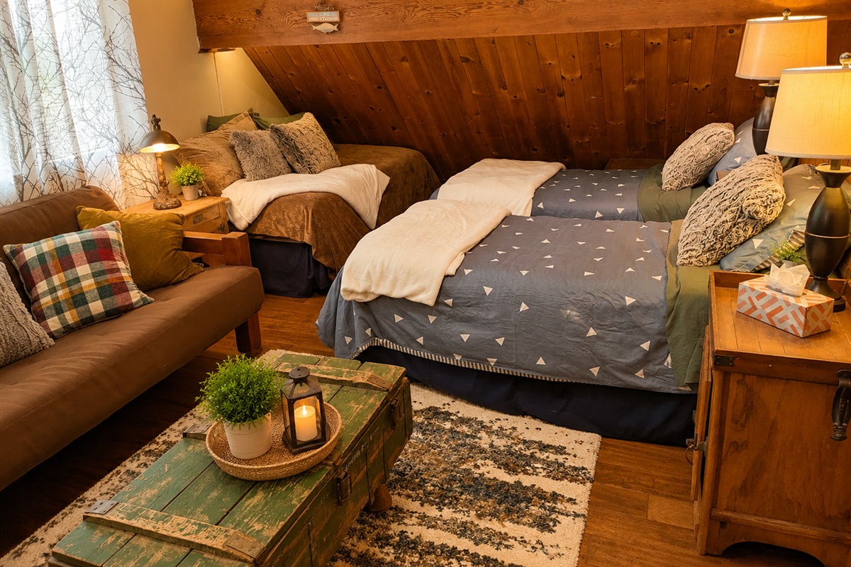 The upstairs loft area has plenty of sleeping space for a larger group as well as separate living space with couch, coffee table, bean bag chairs and tv.