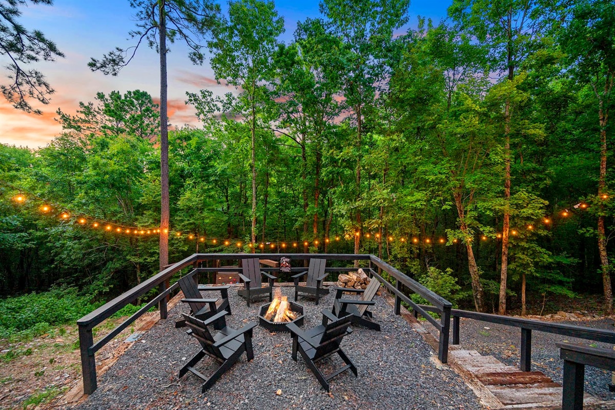 Fire pit area located a few steps below the deck and has 6 comfortable chairs.  A few more steps will take you to the custom built play toy and swings, as well as a cleared gravel path that takes you to a creek!