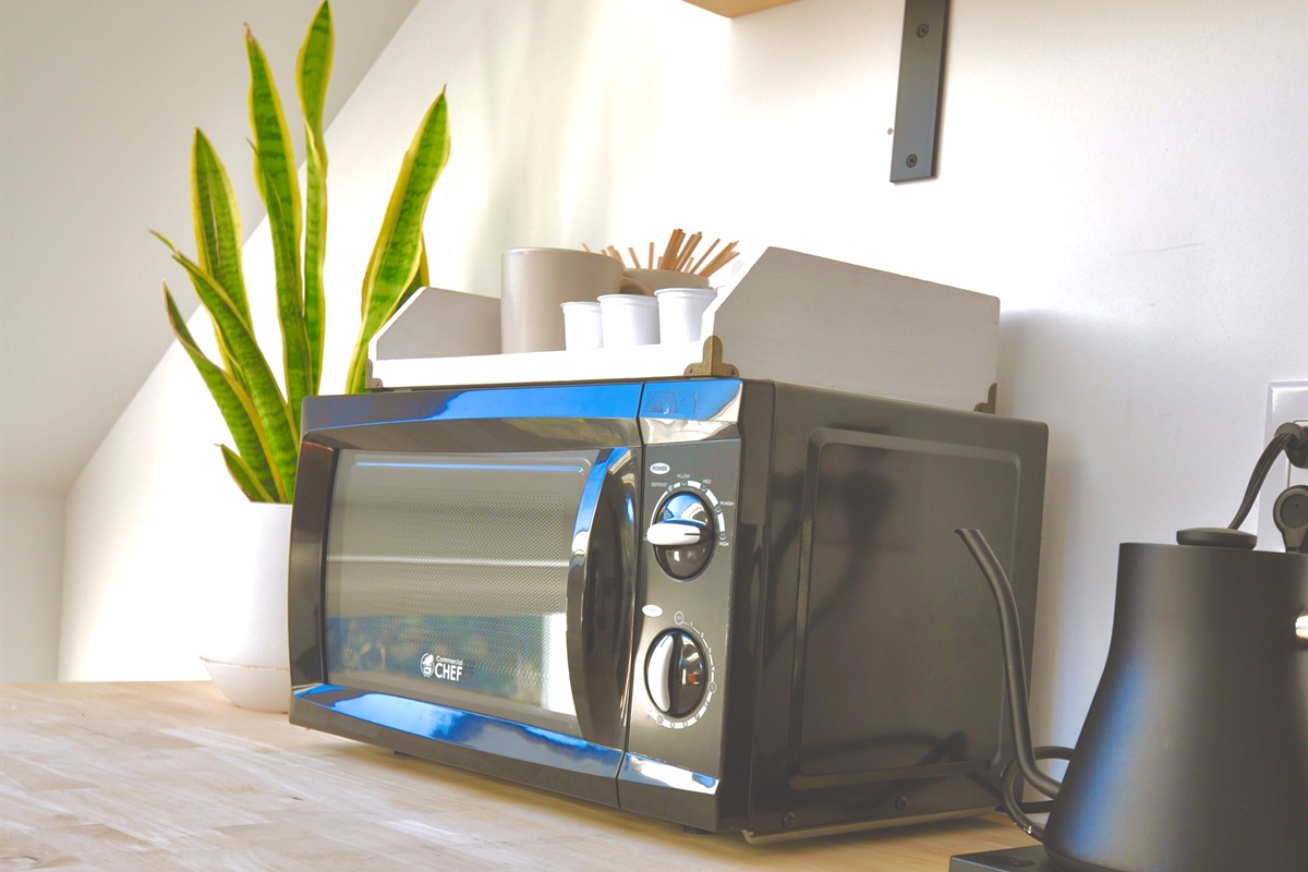 kitchenette with microwave and apartment-sized refrigerator/freezer.