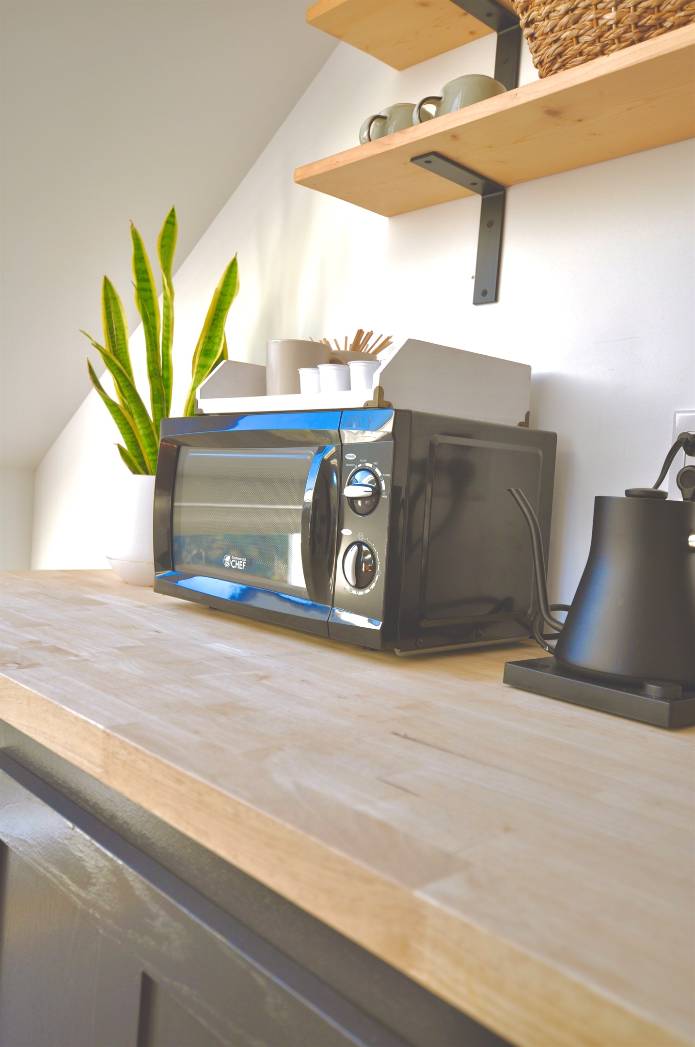 kitchenette with microwave and apartment-sized refrigerator/freezer.