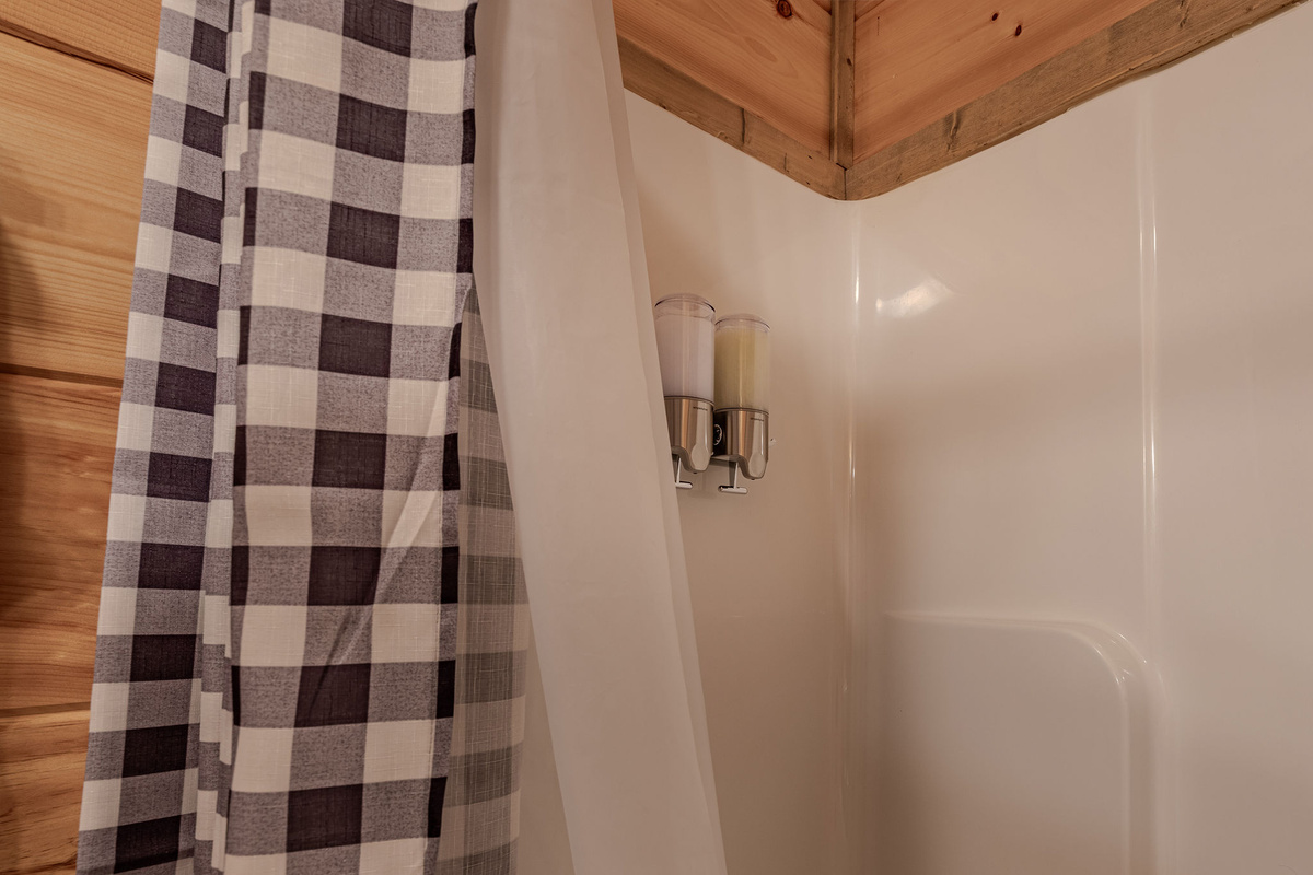 The shared full bathroom is convenient to the upstairs bedrooms and finished with clean cabin-style details.
