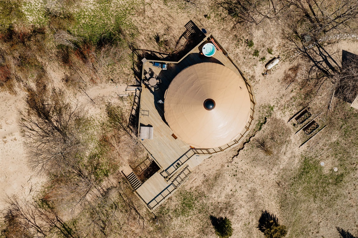 A stunning overhead view of the yurt and expansive deck space tucked into the dunes along Michigan’s breathtaking coastline.