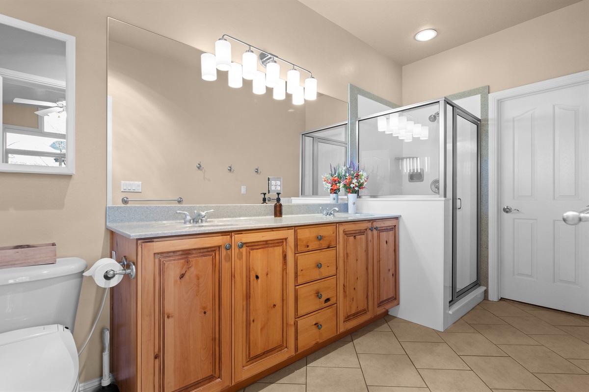 Bright primary bath with dual sinks, walk-in shower, and plenty of space to unwind.