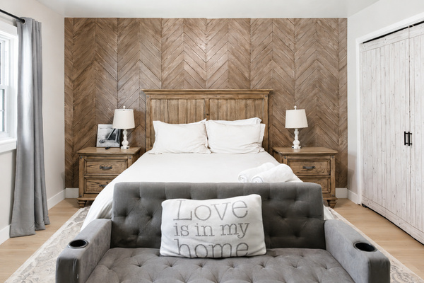 Your comfortable escape: primary bedroom with TV, pull-down couch, desk, soft carpet, dresser, closet, USB lamps, and cozy robes.