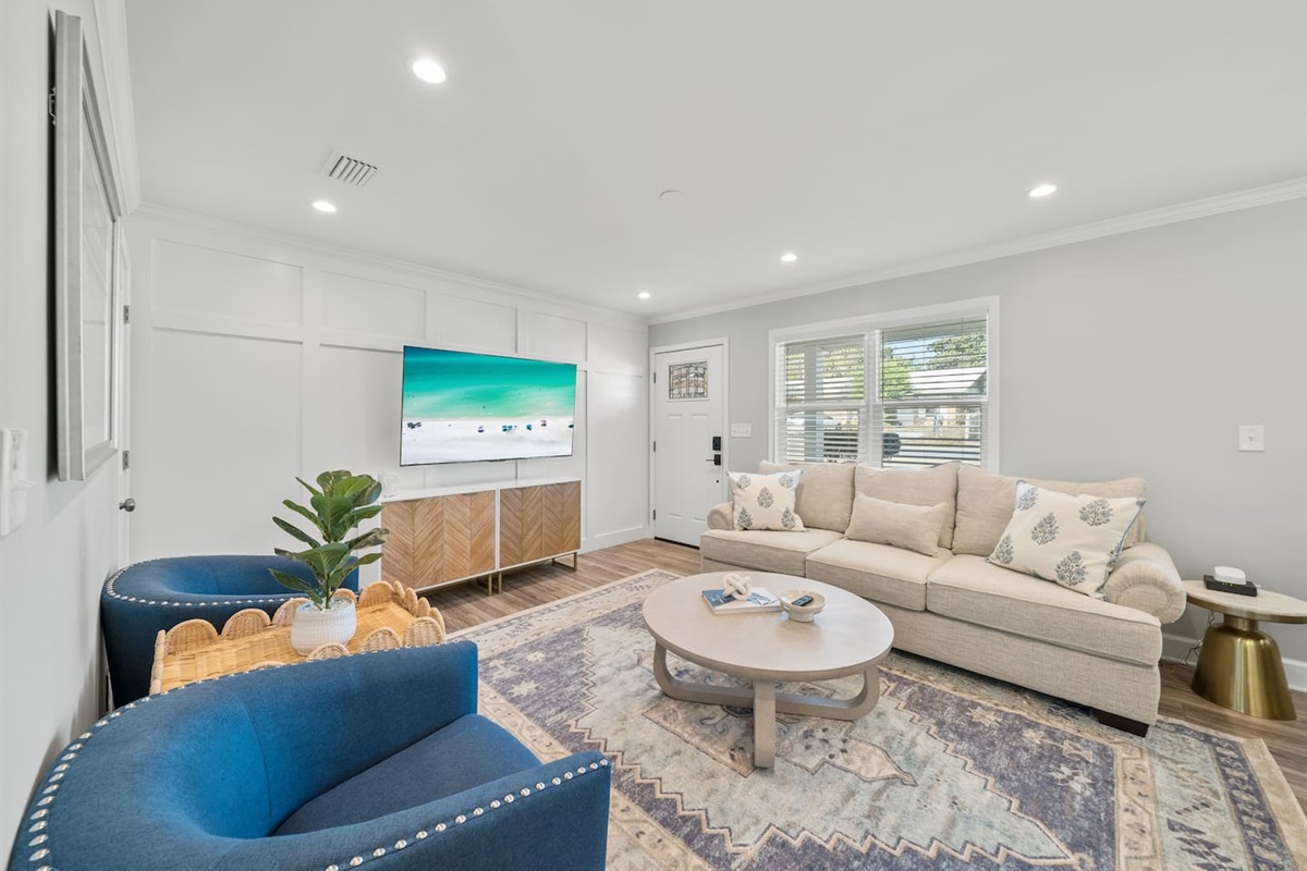 Living room of Unit A. Featuring a sleeper sofa and a smart TV.