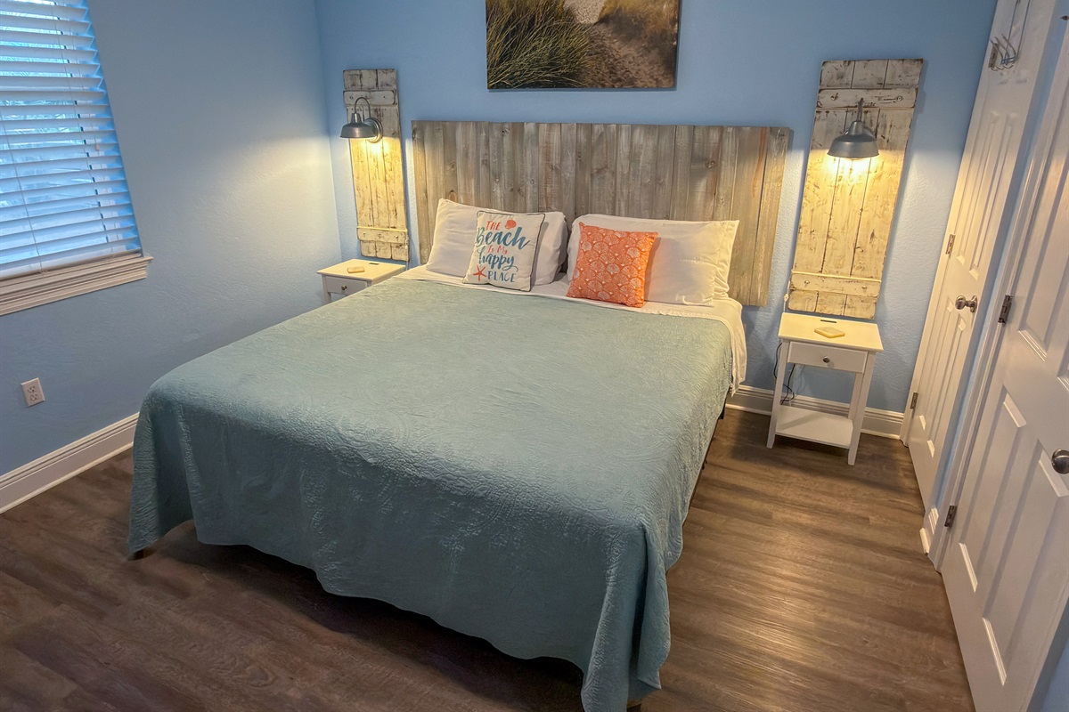 First Floor Bedroom 2 showcases ambient bedside lighting, driftwood-inspired décor, and a cozy King bed for ultimate comfort.