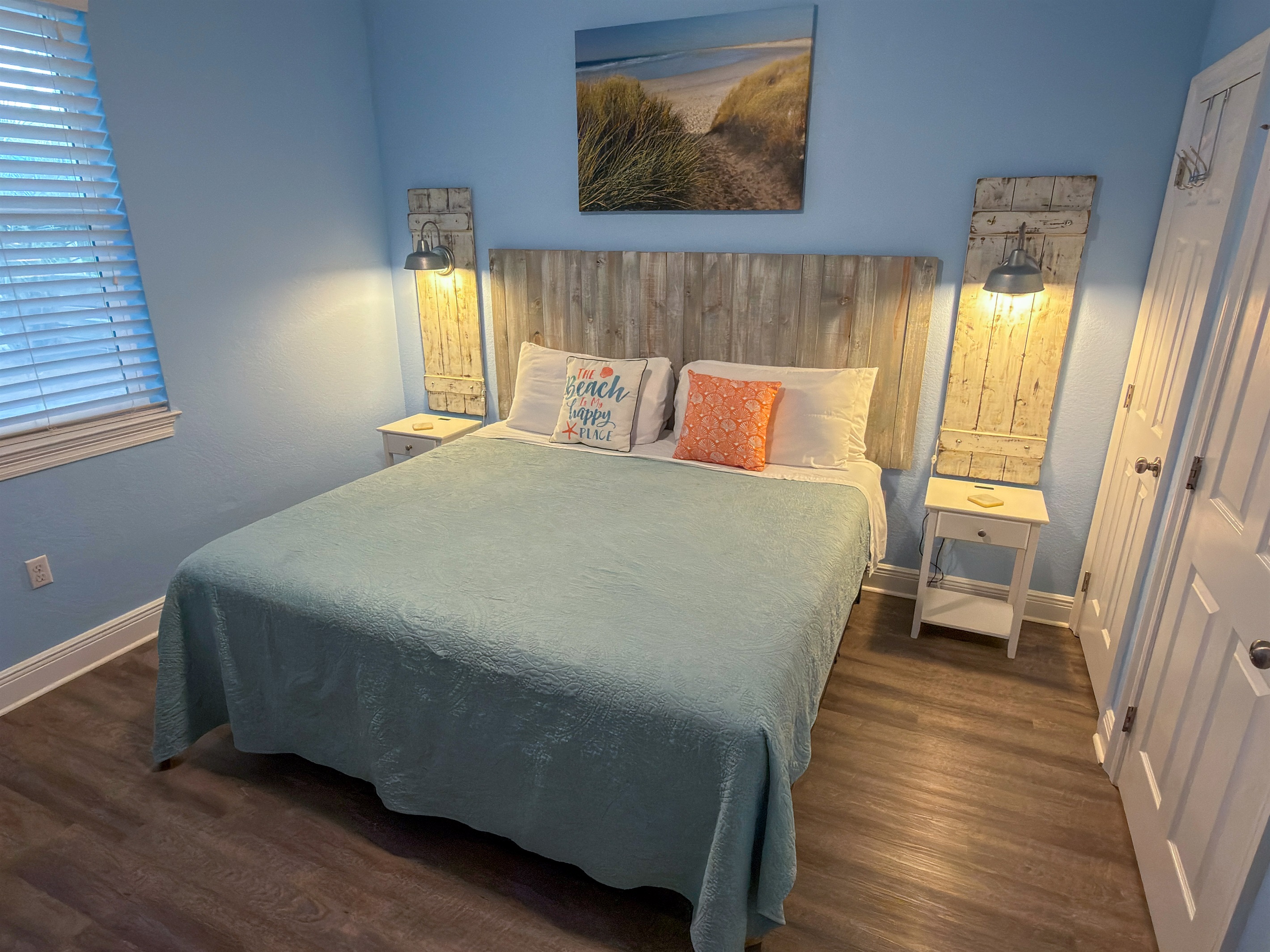 First Floor Bedroom 2 showcases ambient bedside lighting, driftwood-inspired décor, and a cozy King bed for ultimate comfort.