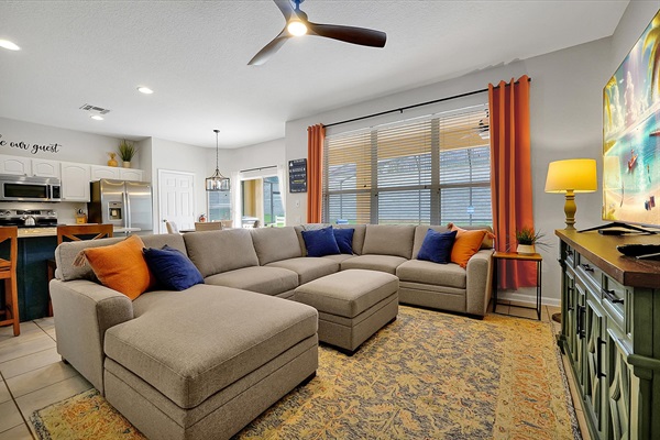 Family Room with comfy couch and 70" TV with Cable