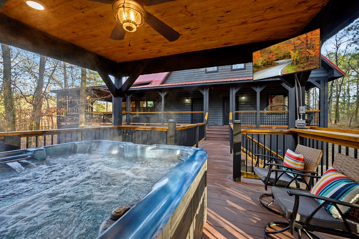Private hot tub deck with smart TV and additional seating.