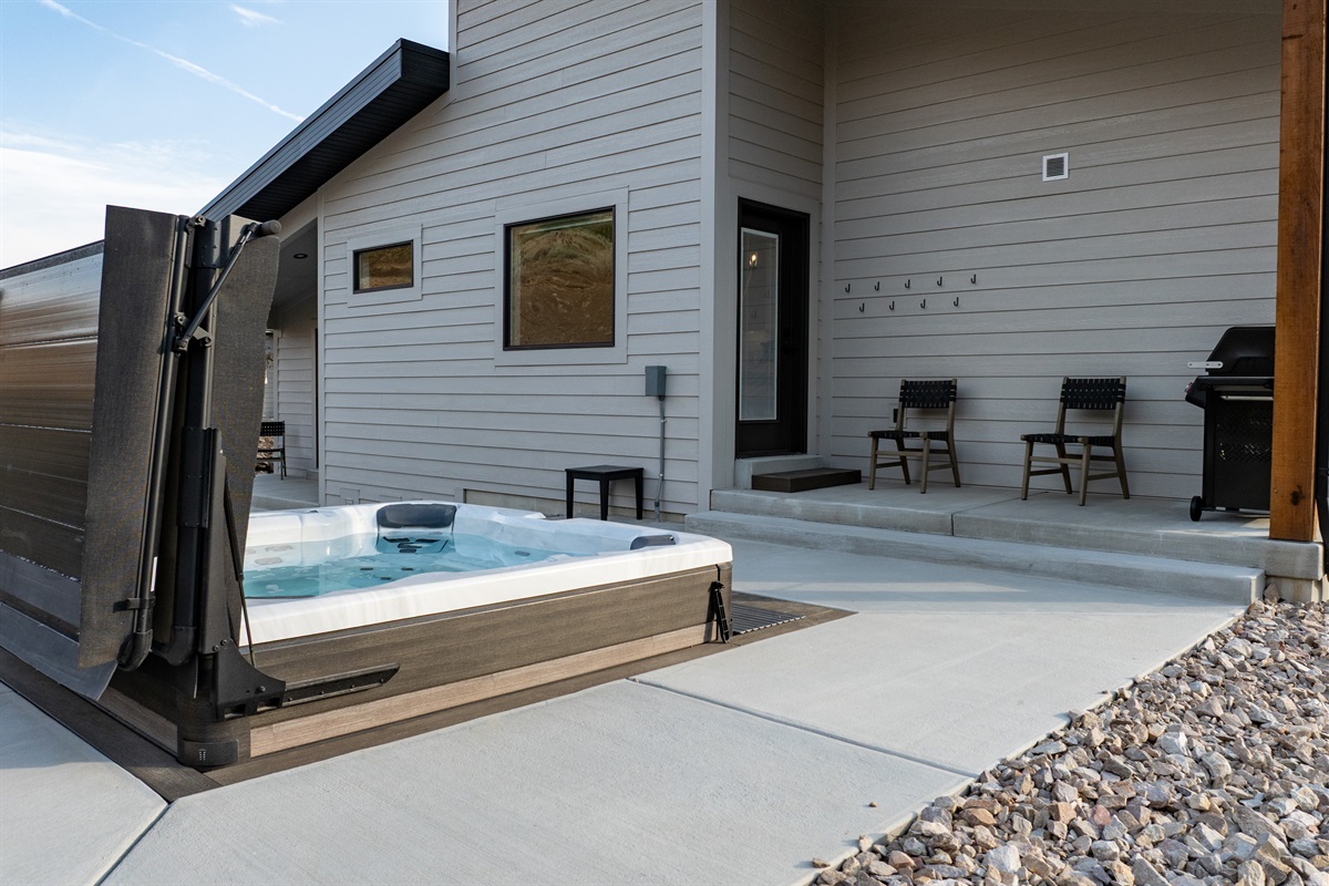 he hot tub is located on the patio near the grill, making it easy to relax while staying connected with the chef.