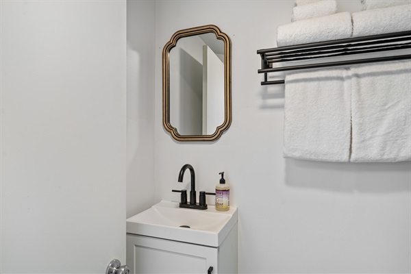For a more modern and elegant experience, a new bathroom vanity and mirror have been installed