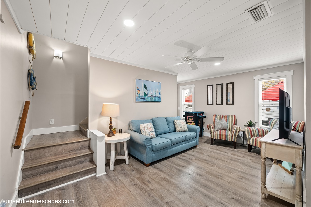 Secondary living room located in the rear of the home. Steps to the left lead up to the loft bedroom and second, upstairs bunk bed room.