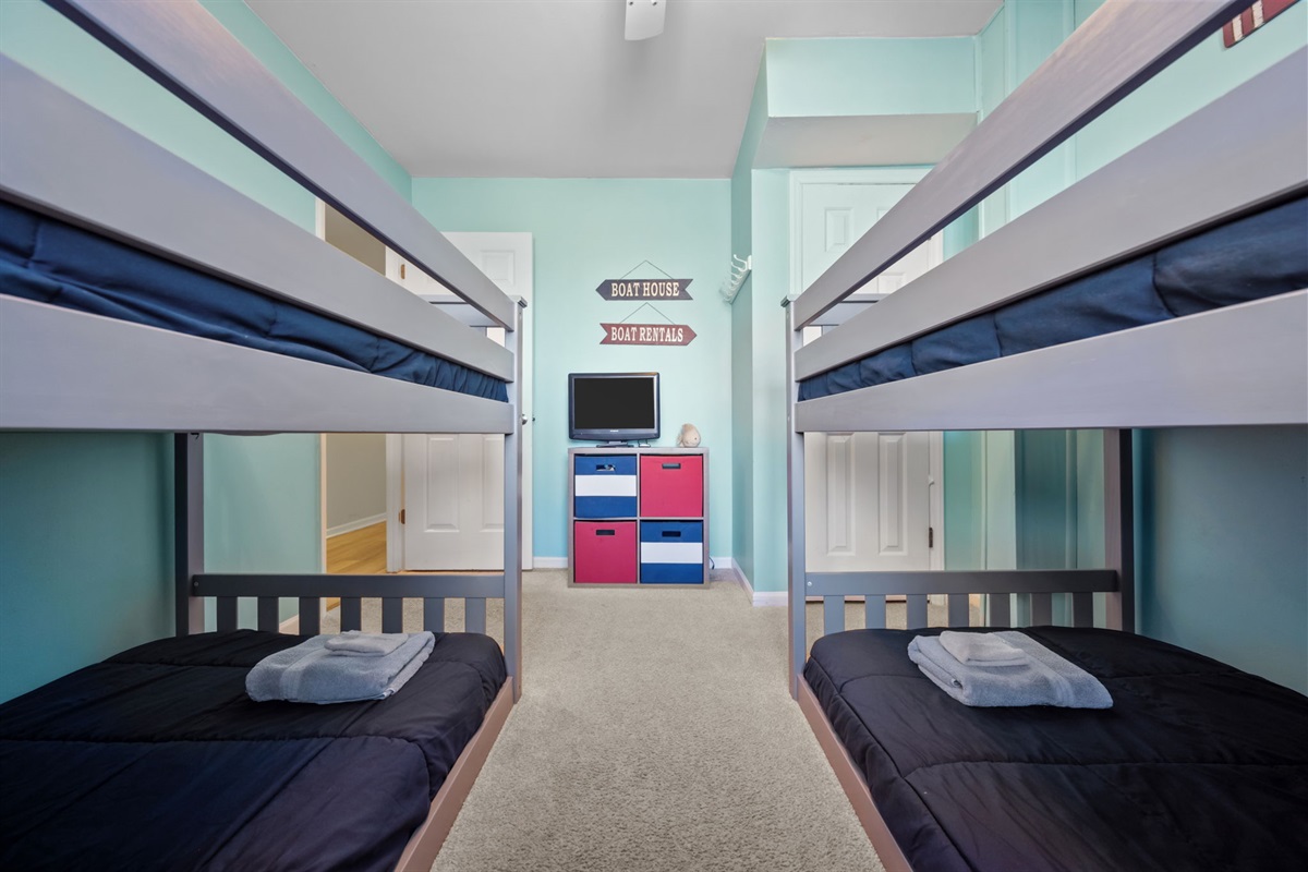 Spacious bunk room with a TV and DVD player so kids can relax with a movie after a full day of adventure