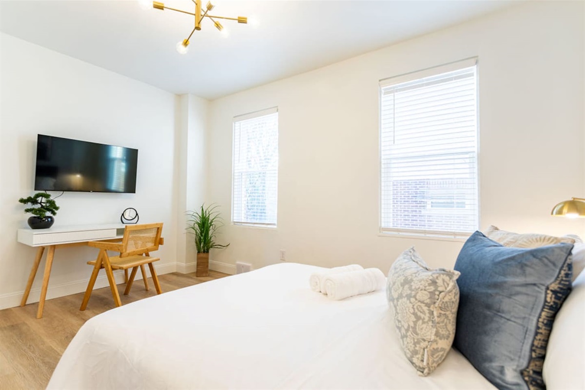 Queen-sized bedroom, with a dedicated workspace. 
