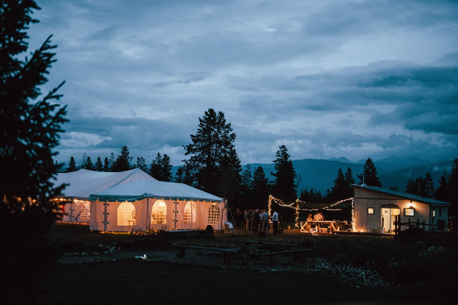 Reception tent lit up at dusk