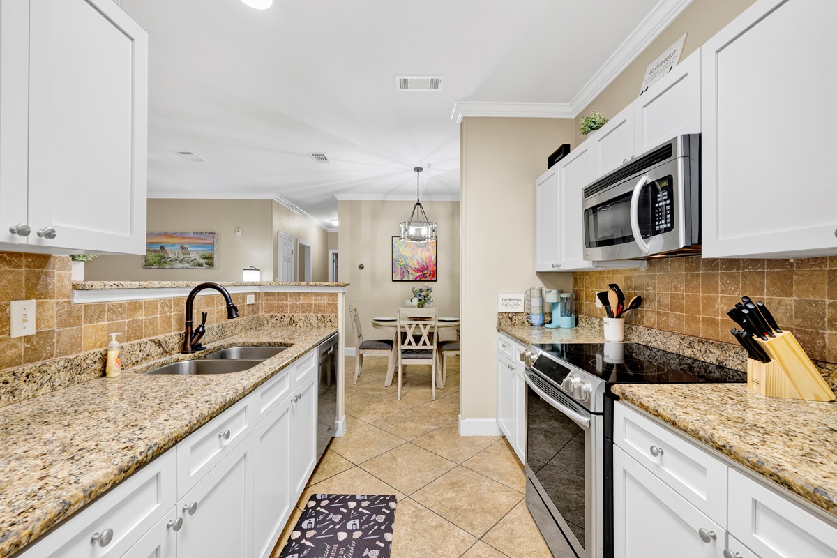 Kitchen with granite tops, stainless appliances and it is fully stocked with everything you need to prepare your meals 