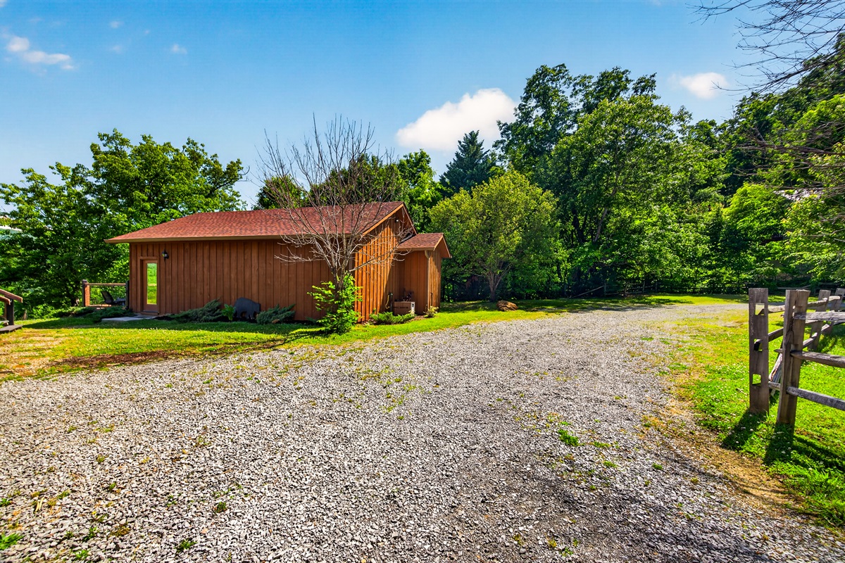 Exterior of Pool House and Level Ground for Ample Parking