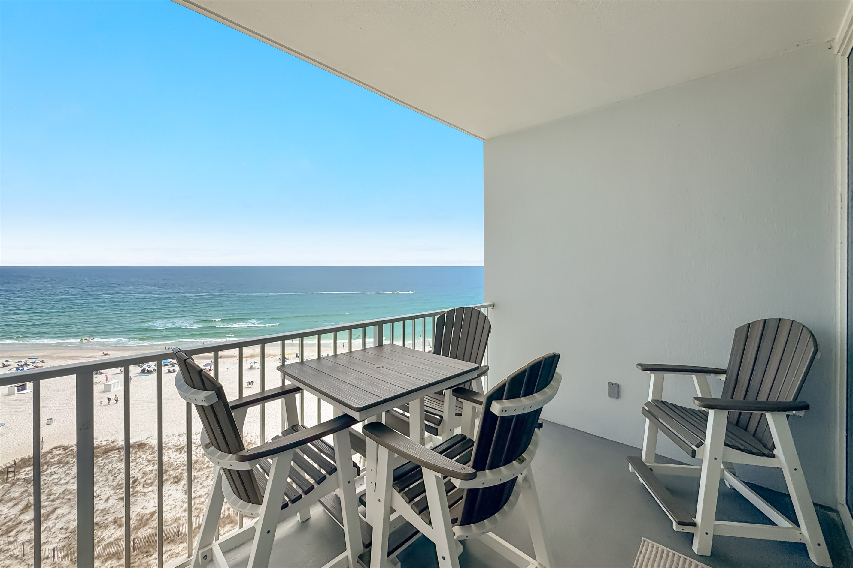 Gain a new perspective on coastal beauty with this panoramic view.  Witness the vastness of the beach and the shimmering sea.