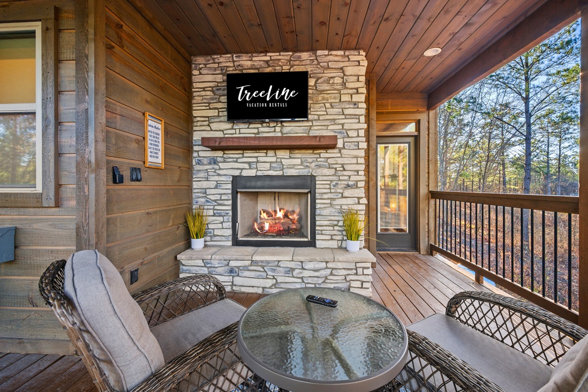 Cozy evenings are easy out here with a covered outdoor fireplace and comfortable seating that invites you to sit back and stay awhile.