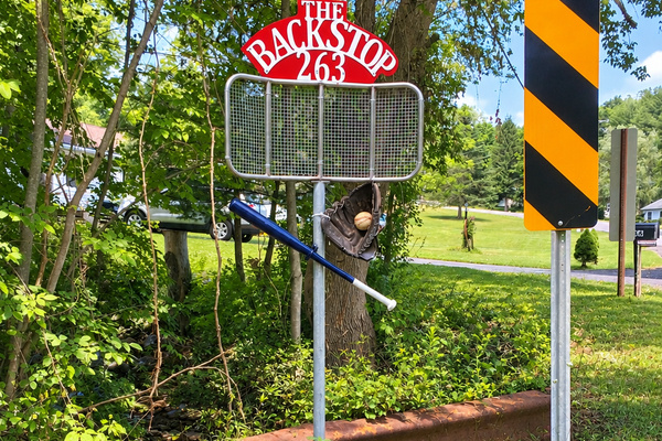 Backstop Apt, welcome sign at the driveway entrance.