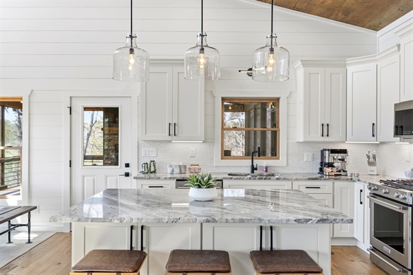 Bright, modern chef’s kitchen with a large natural stone island. Fully equipped with stainless cookware, sharp knives, Dutch oven, crockpot, rice maker, food processor, blender, teapot, and all essential utensils and gadgets.