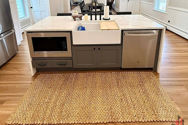 Built-in microwave, farmhouse sink, and dishwasher