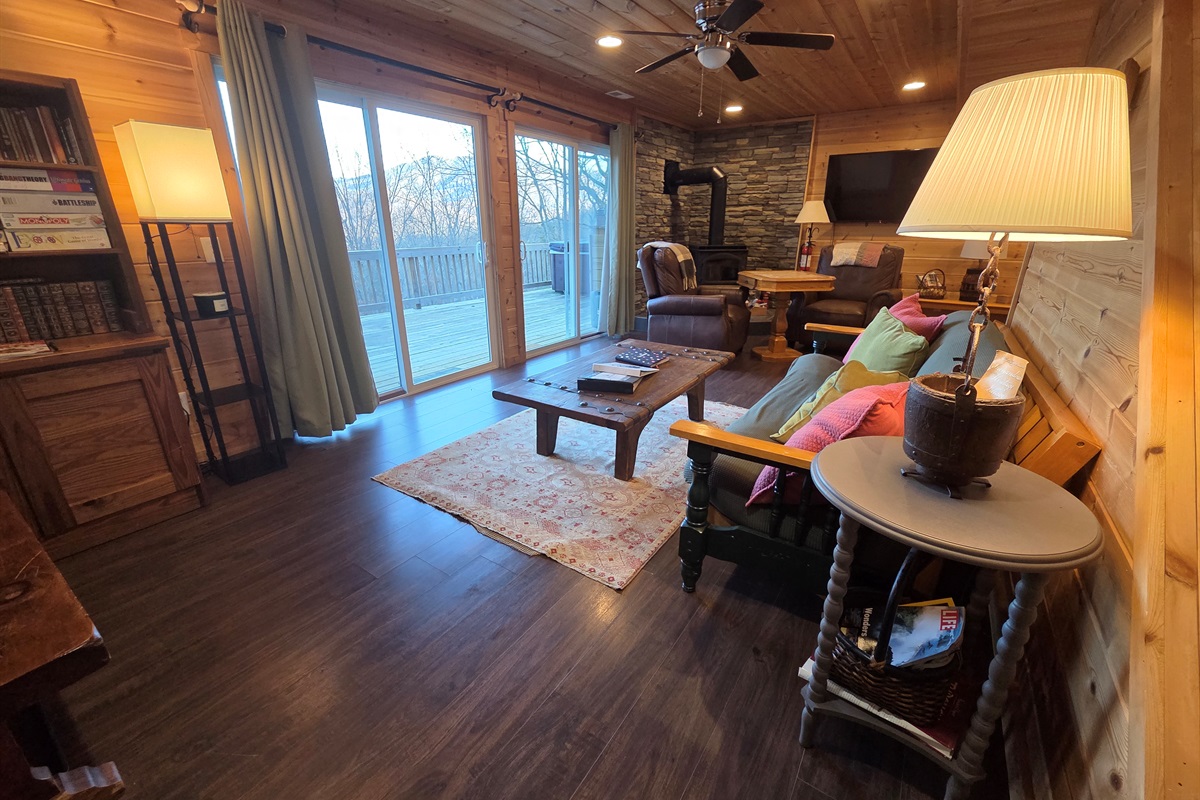 Relax in the spacious, cozy, and rustic living room, complete with a wood-burning fireplace and stunning views.