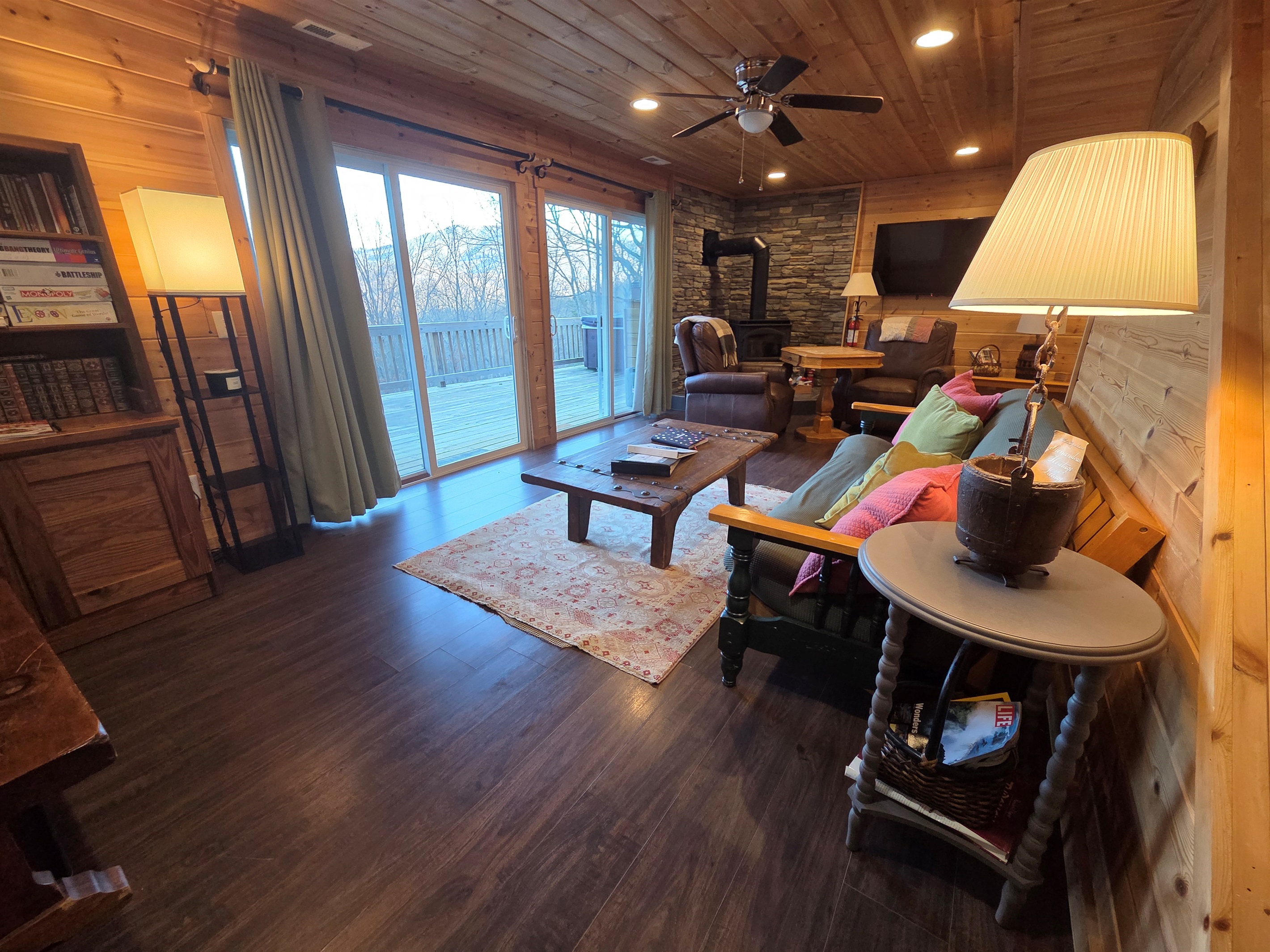 Relax in the spacious, cozy, and rustic living room, complete with a wood-burning fireplace and stunning views.