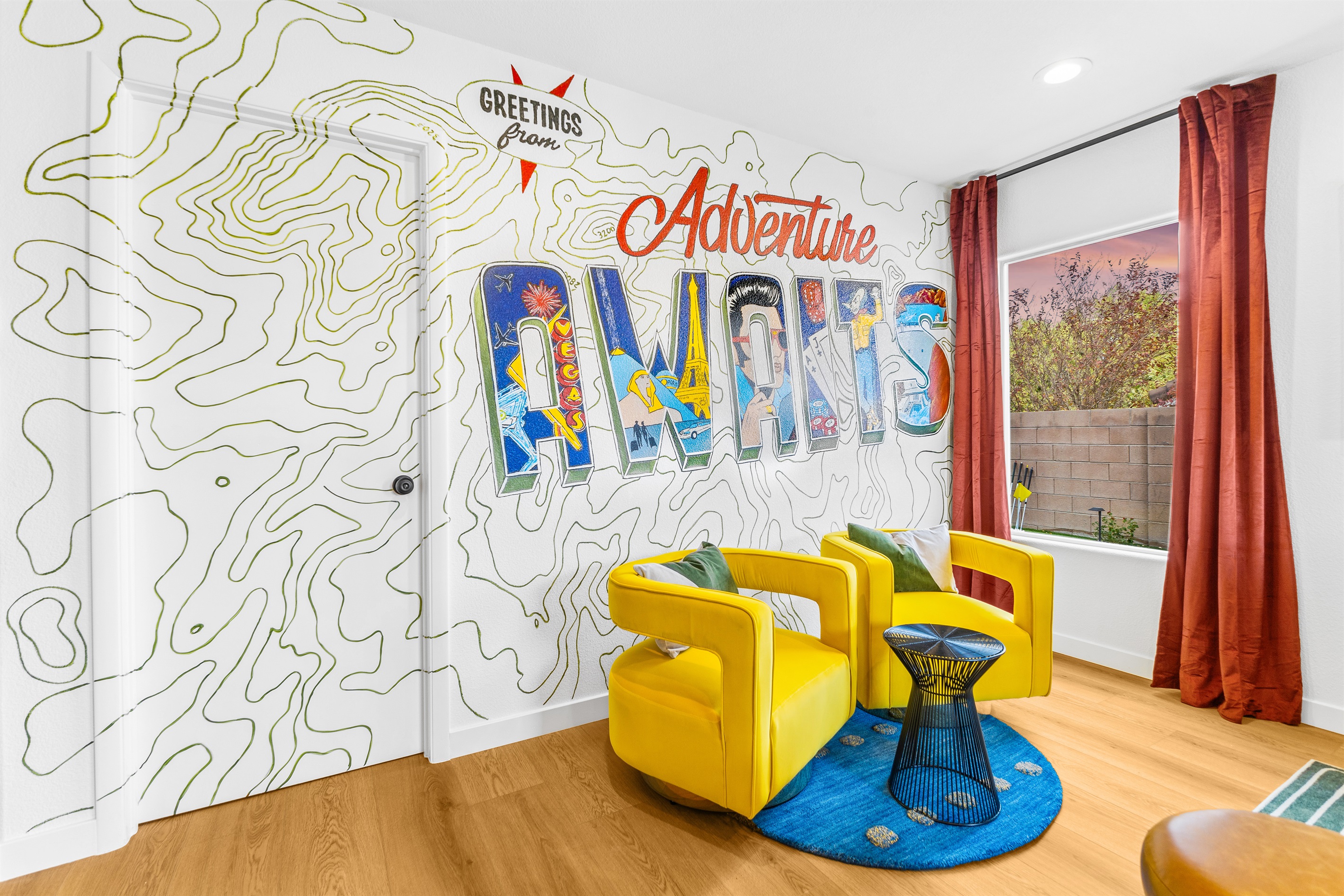 Our instaworthy postcard wall where you can take and send greeting photos back home.  Hand-drawn by a local artist.  Did you know??? The topographic lines on this wall are not random lines.  They are of the McCollough Range behind our home! Just WOW!