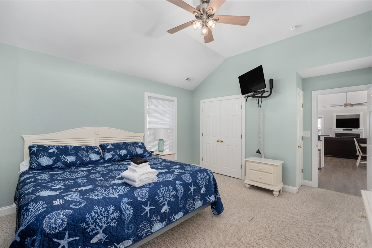 Cozy king bedroom with soft natural light.