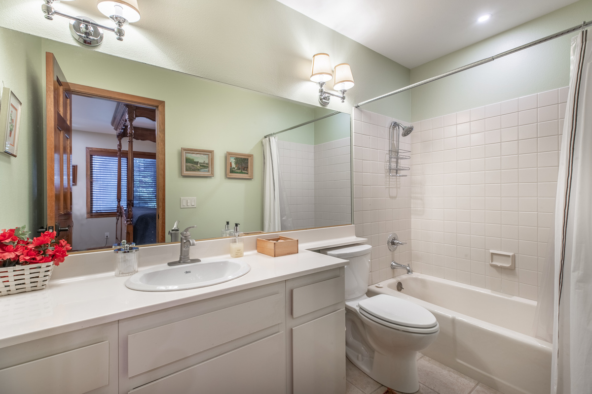 Bright ensuite with vanity and soaking tub for the West bedroom.