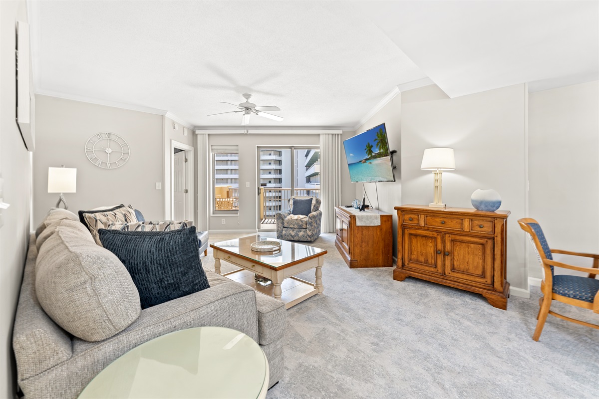 Comfortable Living Room with large TV and balcony access