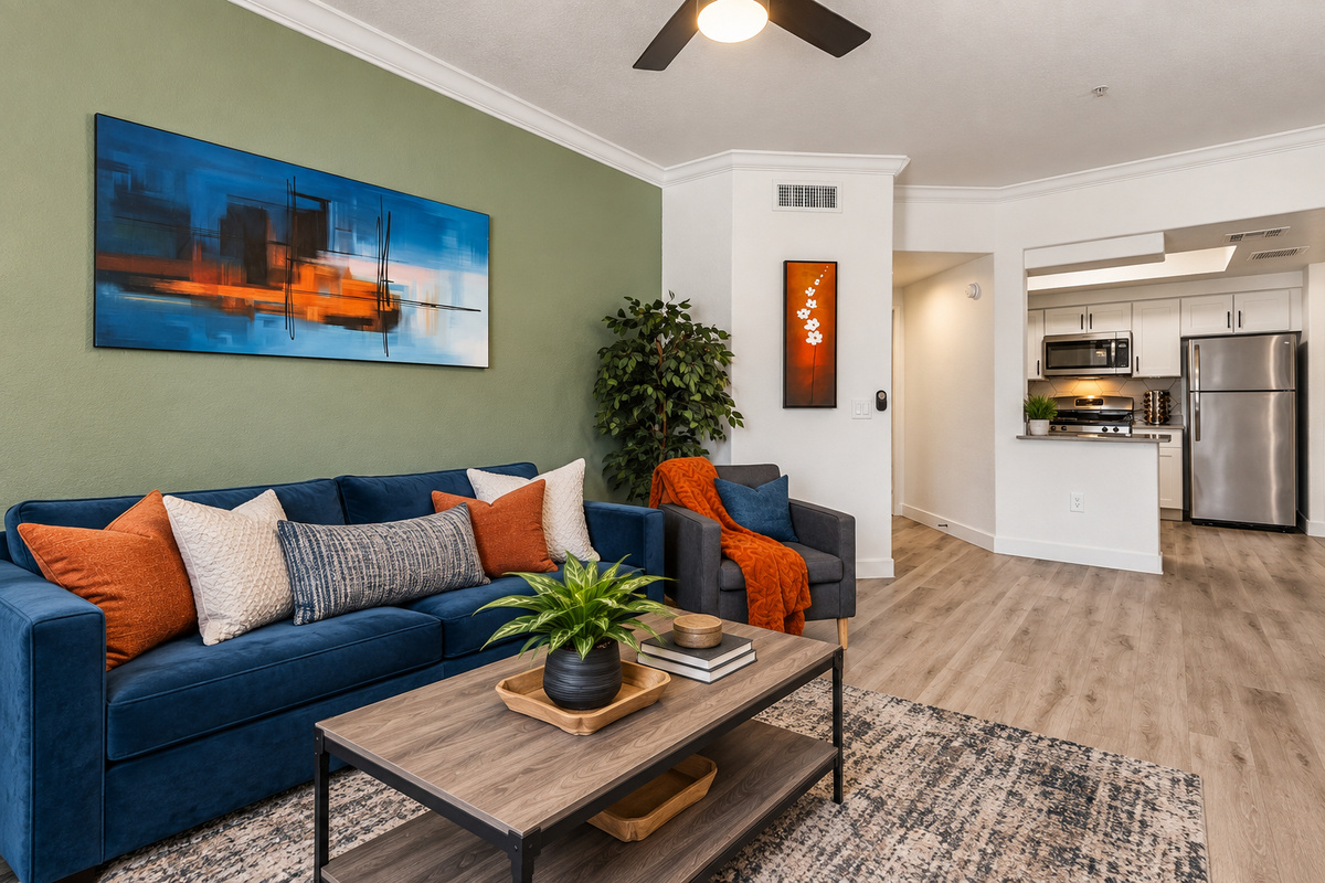 Stylish living room with plush velvet sofa, modern kitchen with stainless steel appliances, and vibrant décor for a comfortable stay in Phoenix