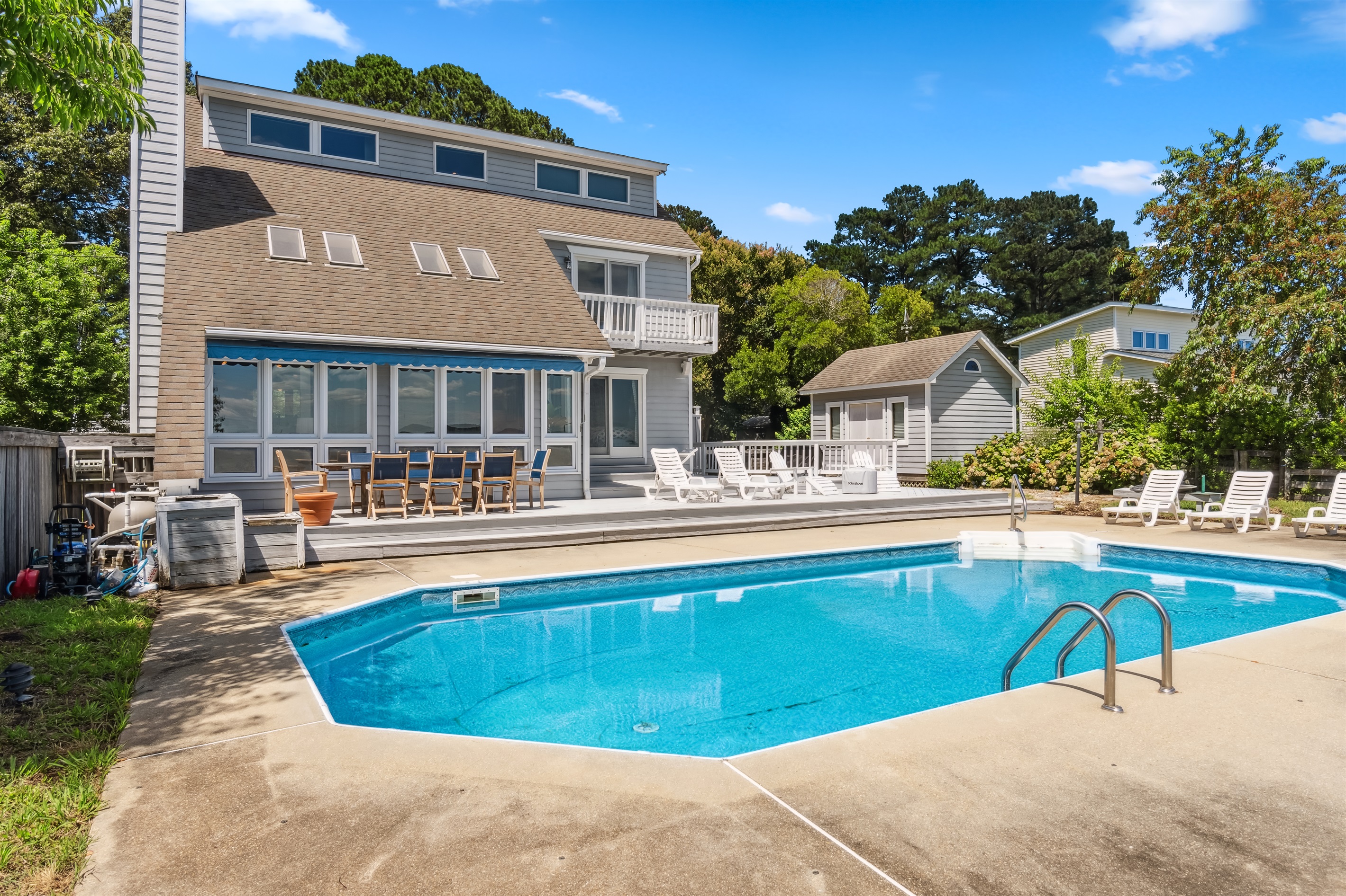 Spacious private pool with sun deck, dining area, and loungers resort style relaxation.