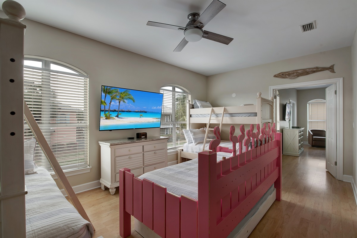 Bunk room with playful pink bunks and Smart TV
