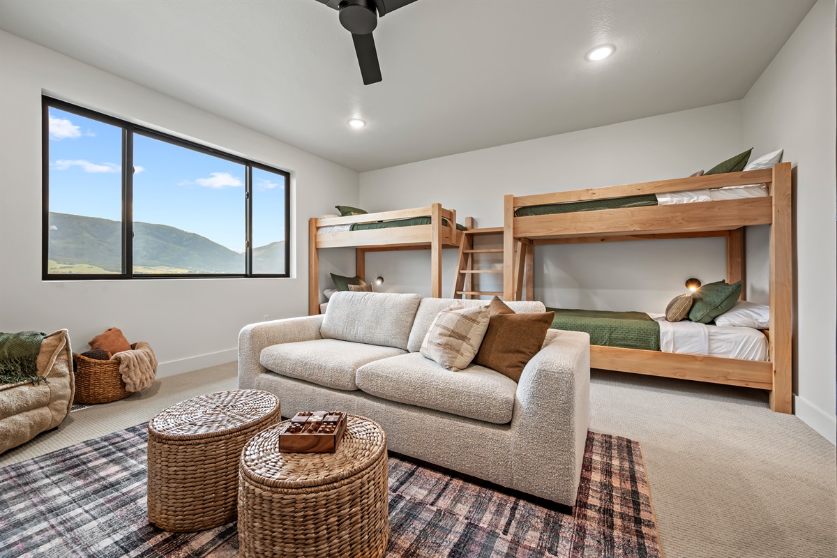 Four twin beds in custom wood bunks make this the perfect hangout for kids or groups — with sweeping mountain views out the window.