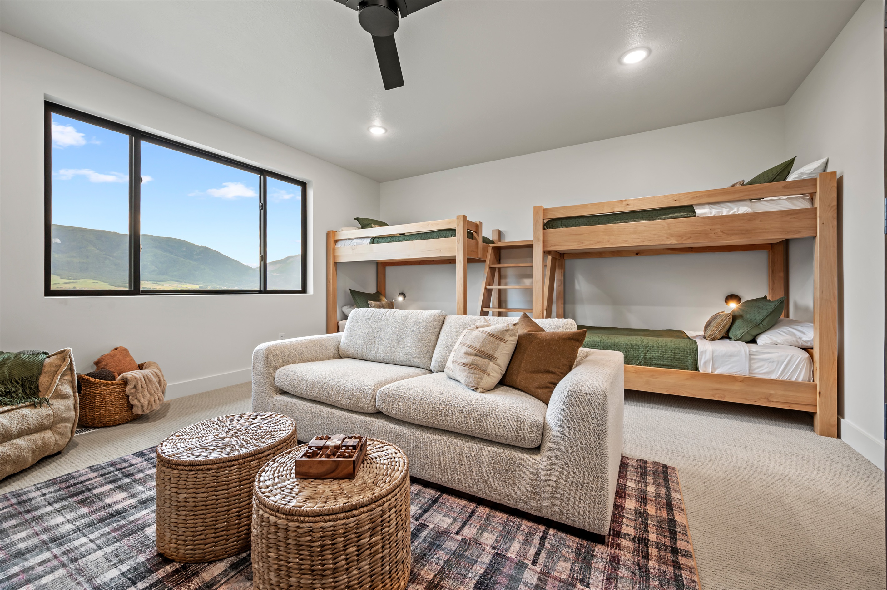 Four twin beds in custom wood bunks make this the perfect hangout for kids or groups — with sweeping mountain views out the window.