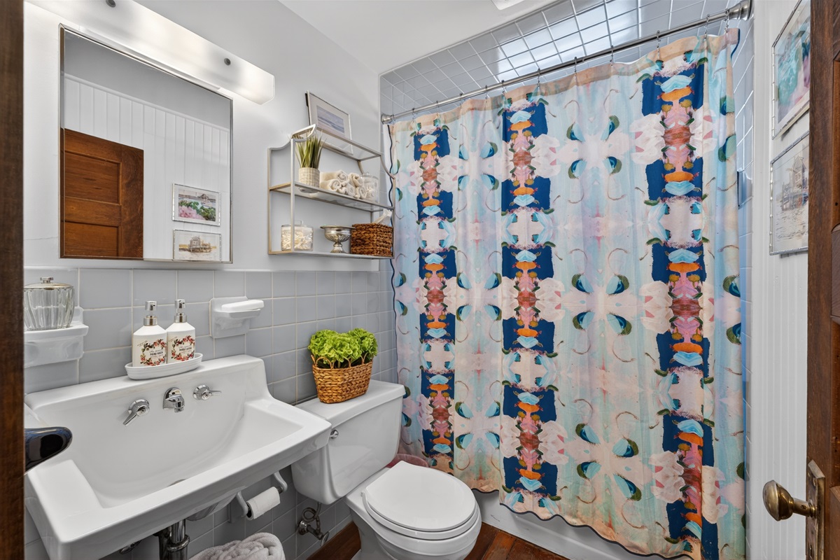 A bright and welcoming full hallway bathroom on the second floor, complete with a relaxing tub/shower combo!
