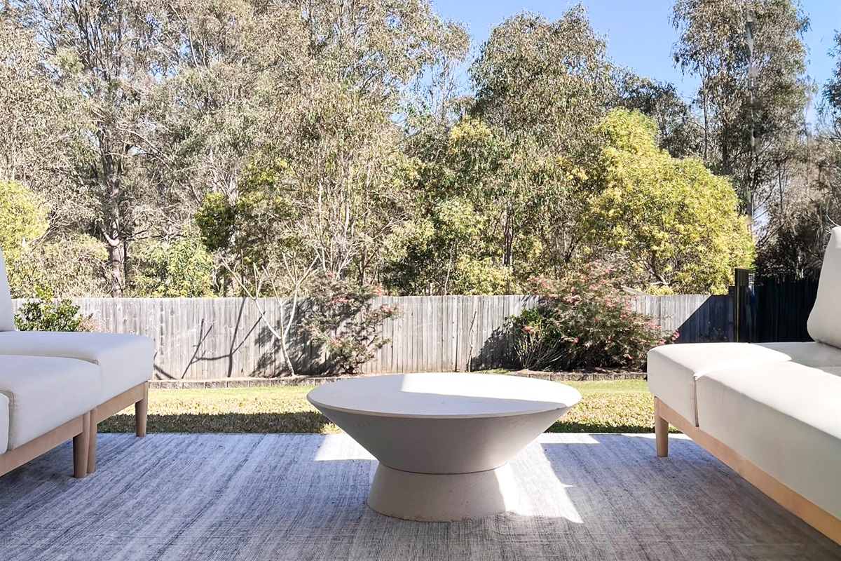 The patio seating fits 6–8 people and sits close to the lawn, BBQ area and sliding doors from the living room.