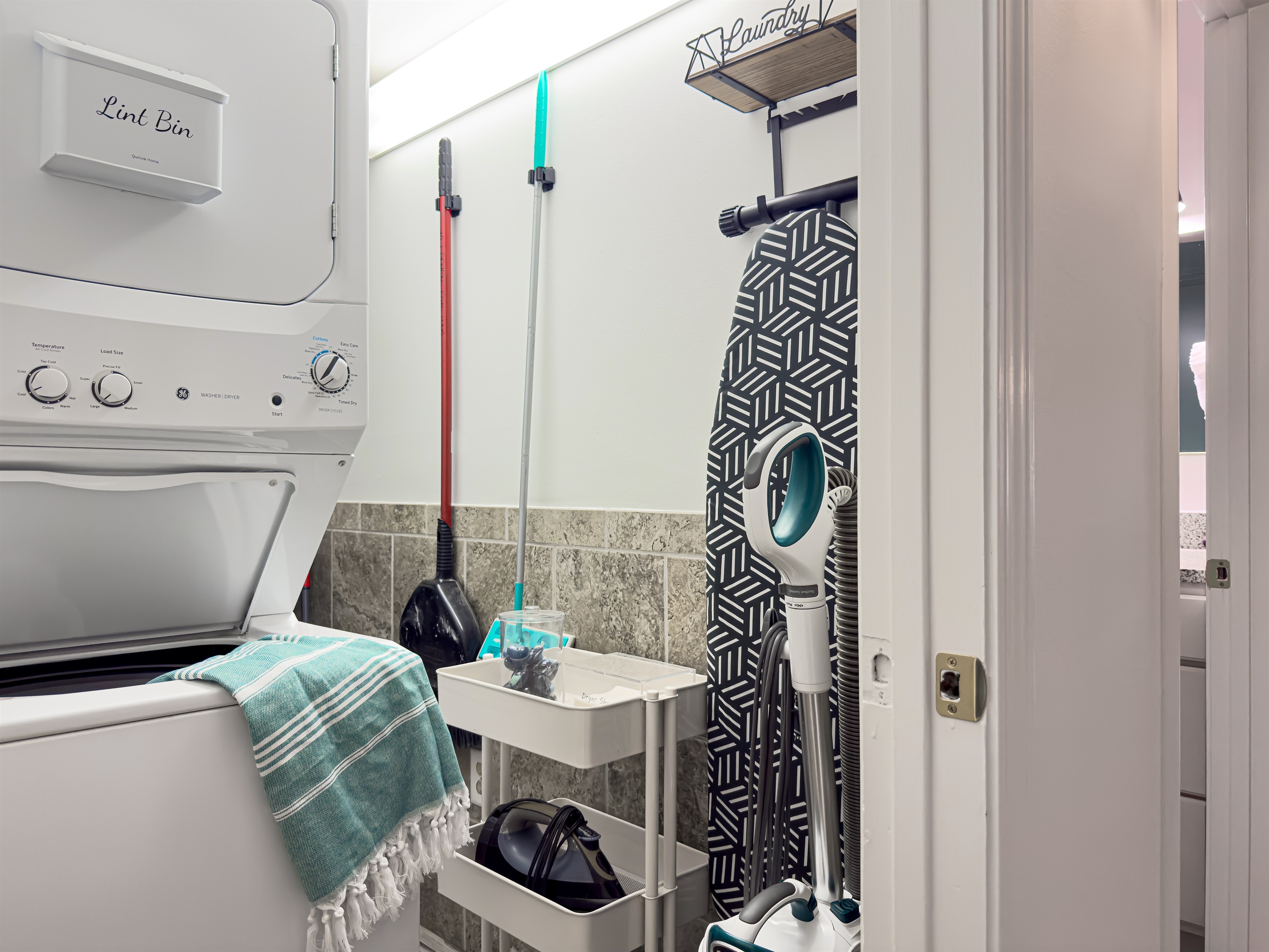 Fully loaded laundry room in-suite offers everything you'll need to ensure proper laundry is attainable! Laundry pods, dryer sheets, cleaning supplies, iron and ironing board are at the ready.