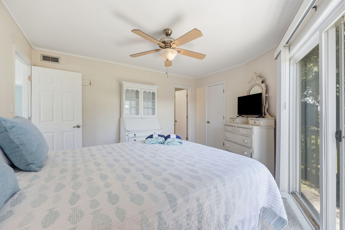 Cozy bedroom featuring a Smart TV and plenty of storage