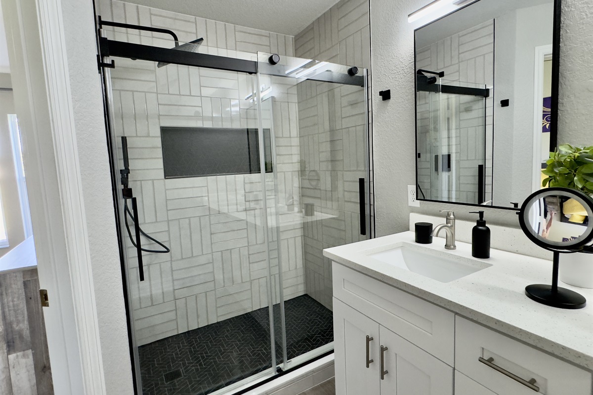 Beauty and the Beast ensuite with custom tile, double sinks, and rain shower