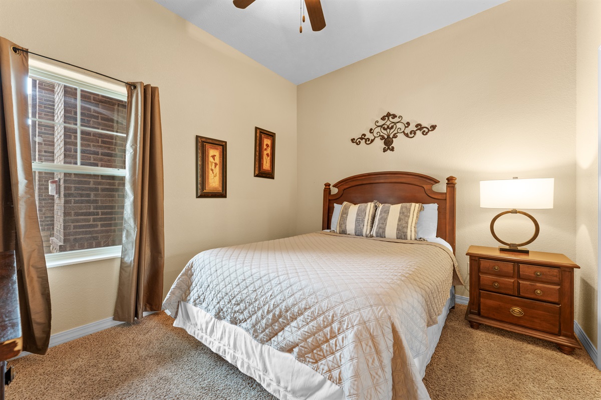 The second bedroom offers a comfortable queen bed and a quiet place to recharge.