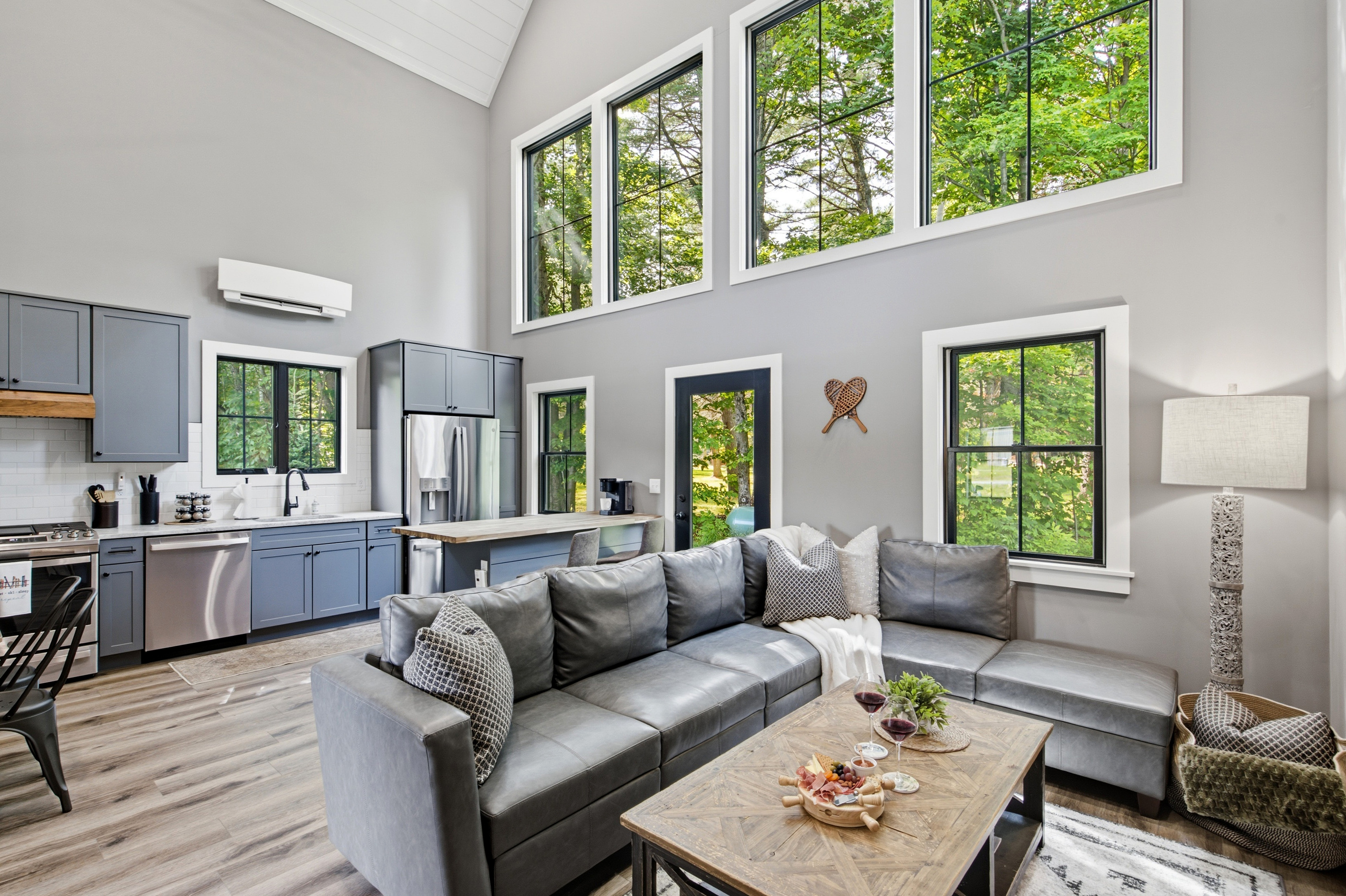 Rest comfortably in a spacious bedroom with large windows and a calm, inviting atmosphere.