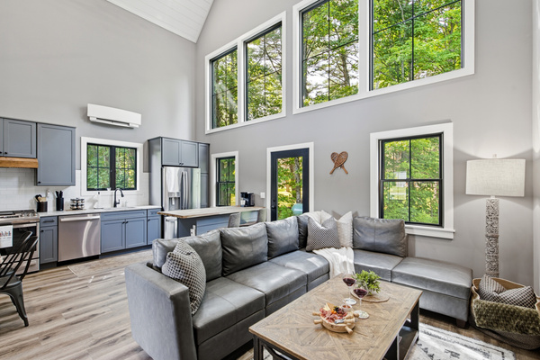 Rest comfortably in a spacious bedroom with large windows and a calm, inviting atmosphere.
