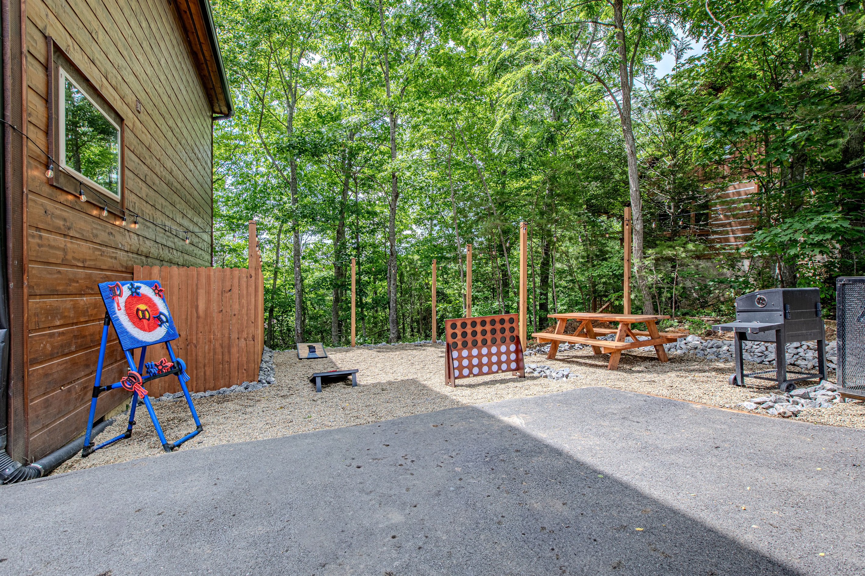 Cornhole, Connect 4, picnic table, and charcoal grill — fun for all ages.