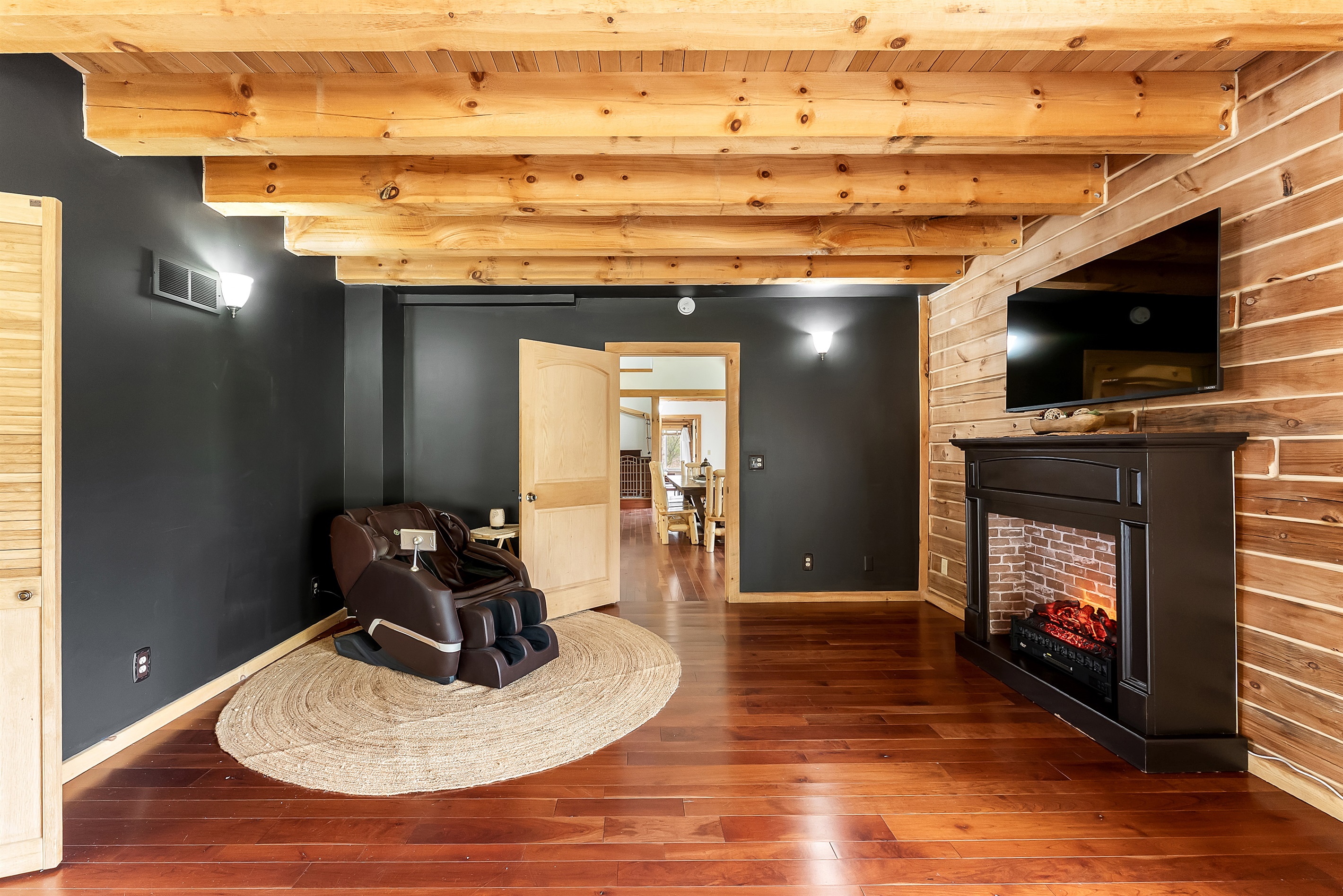 Room off of master bedroom with massage chair and TV.