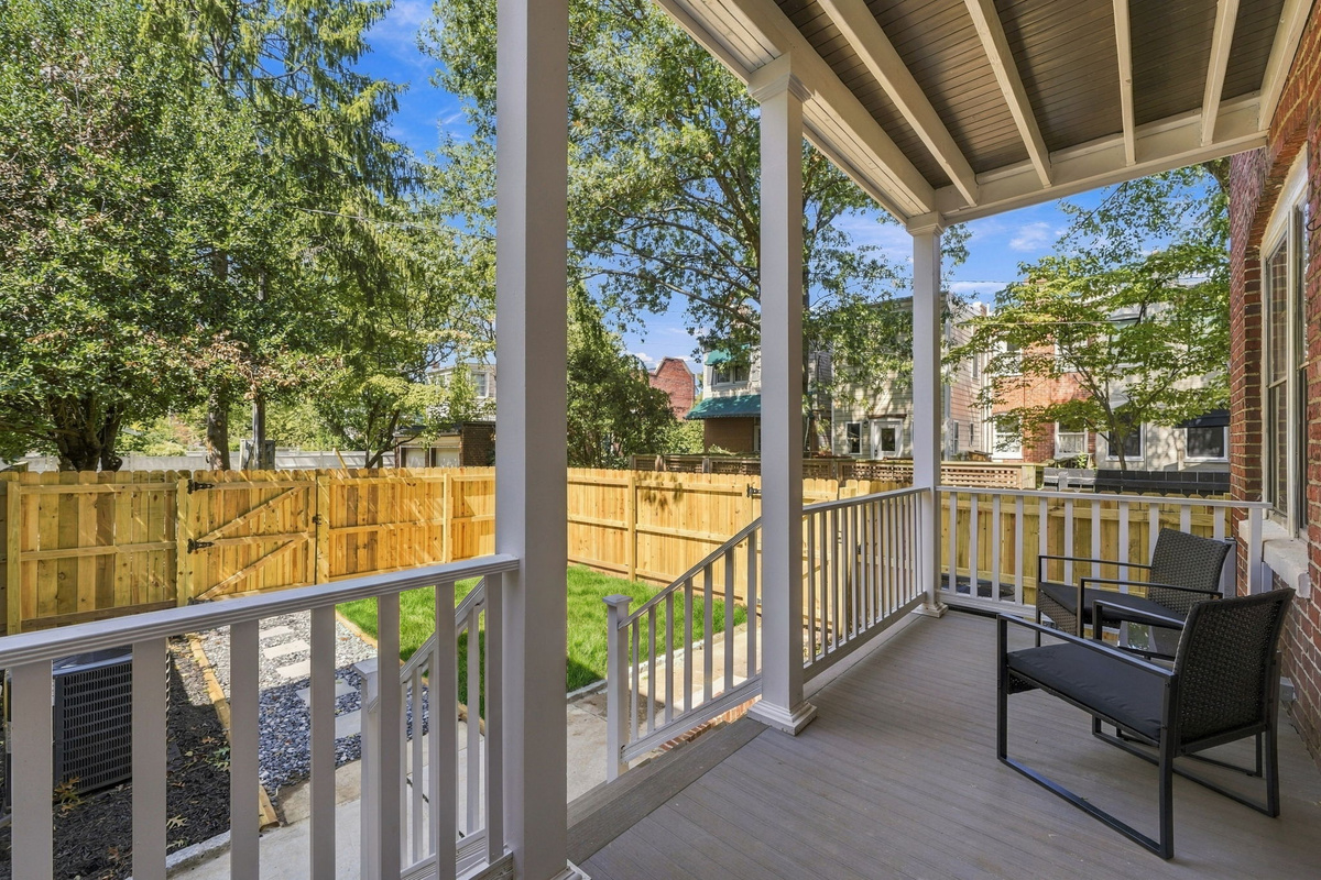 Porch Paradise: Relax on the sunny porch with views of the charming backyard oasis!